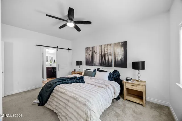 a bedroom with a bed and a flat tv screen