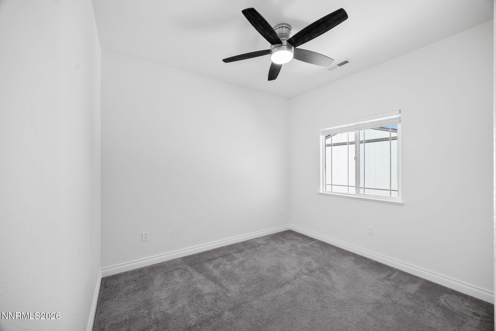 19013 Alpine Walk Reno, NV 89508 - Photo 24 of 34 an empty room with a window and a fan