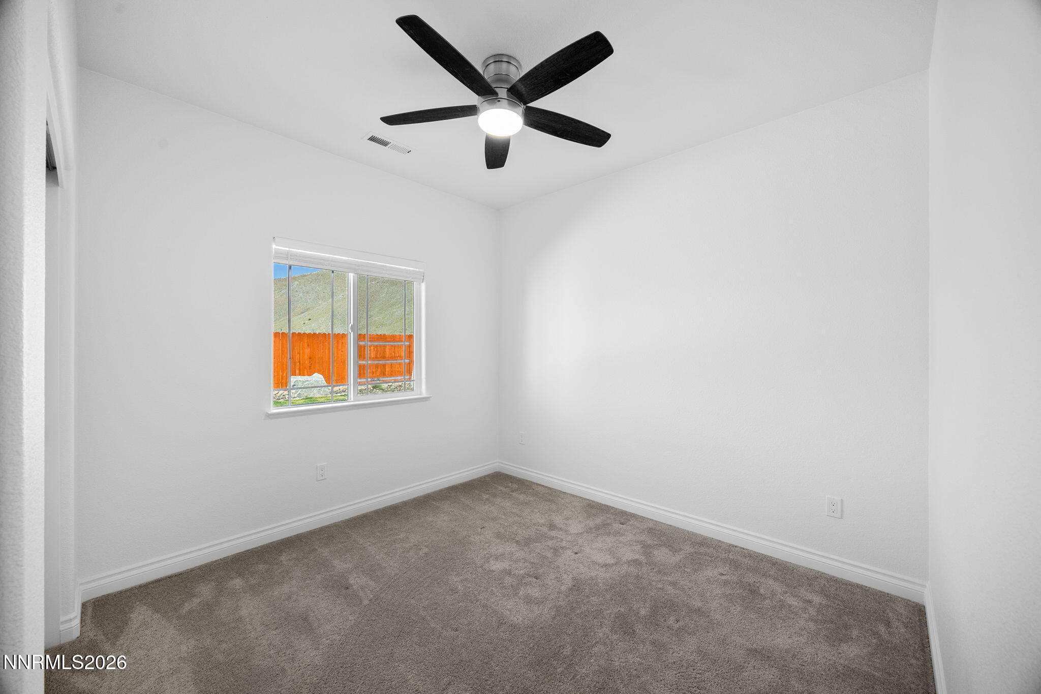 19013 Alpine Walk Reno, NV 89508 - Photo 25 of 34 an empty room with window and ceiling fan