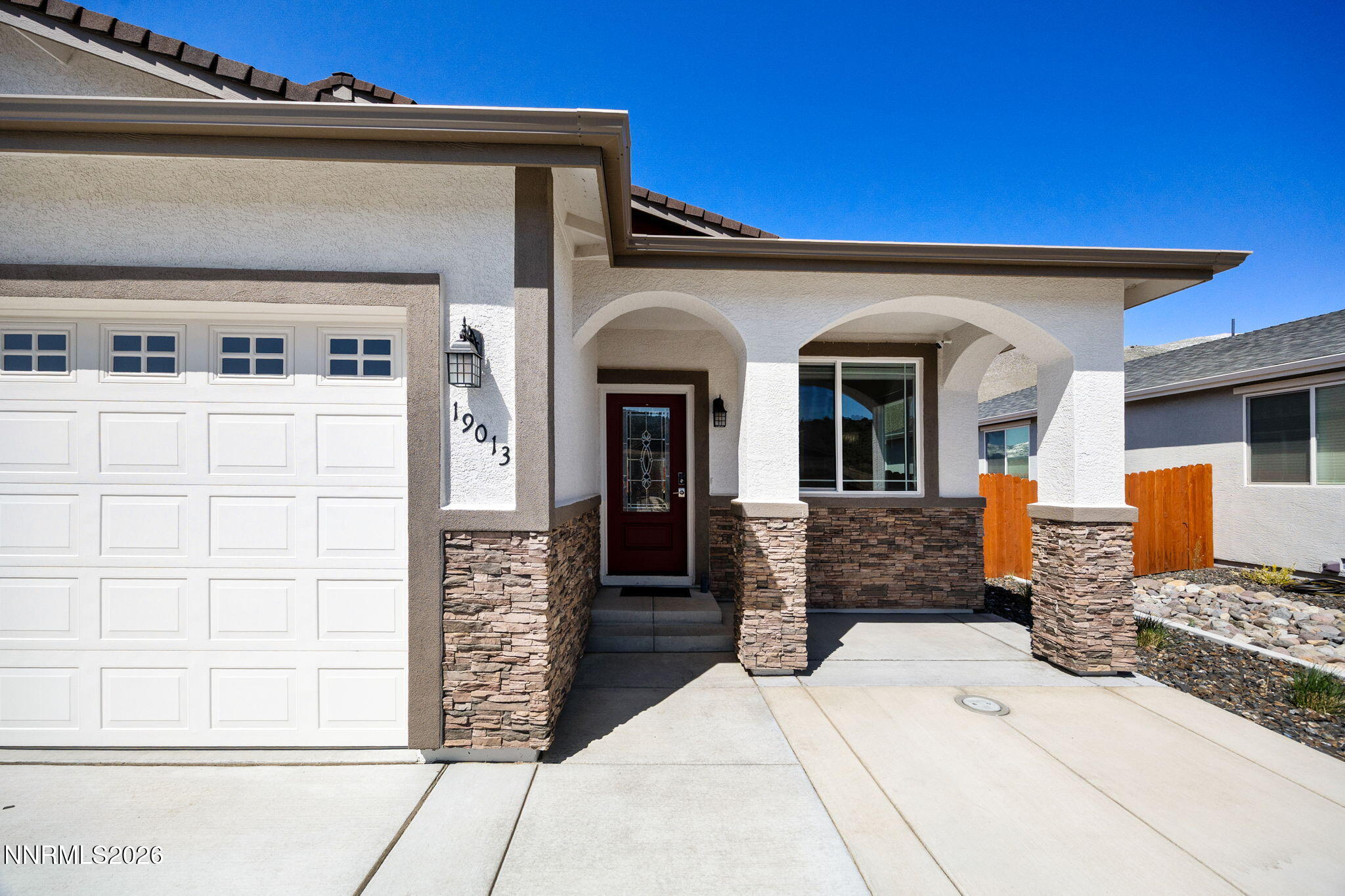 19013 Alpine Walk Reno, NV 89508 - Photo 4 of 34 a front view of a house with glass windows and furniture