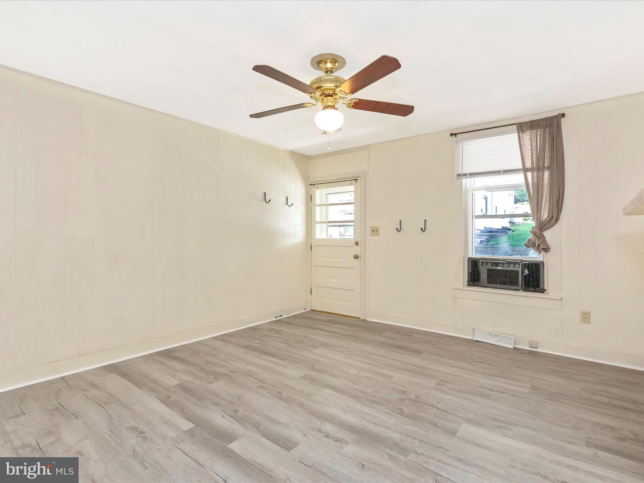 1404 Pleasant Valley Road, Unit 2 Westminster, MD 21158 - Photo 13 of 43 an empty room with wooden floor fan and windows