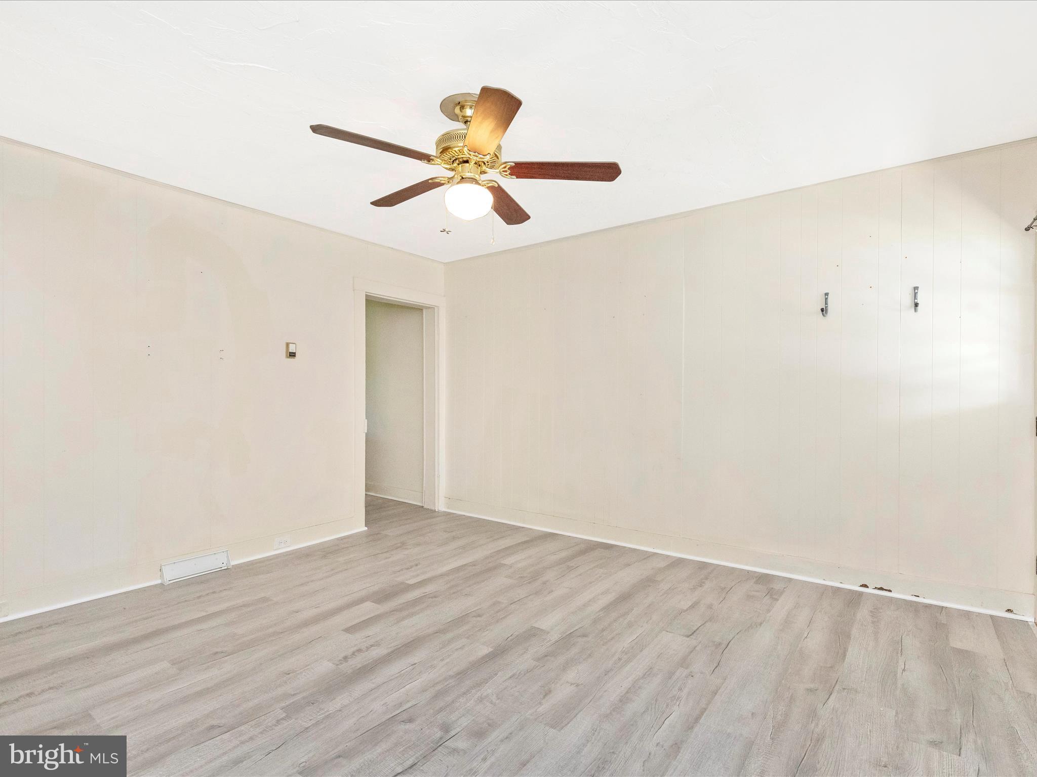 1404 Pleasant Valley Road, Unit 2 Westminster, MD 21158 - Photo 15 of 43 an empty room with wooden floor and windows