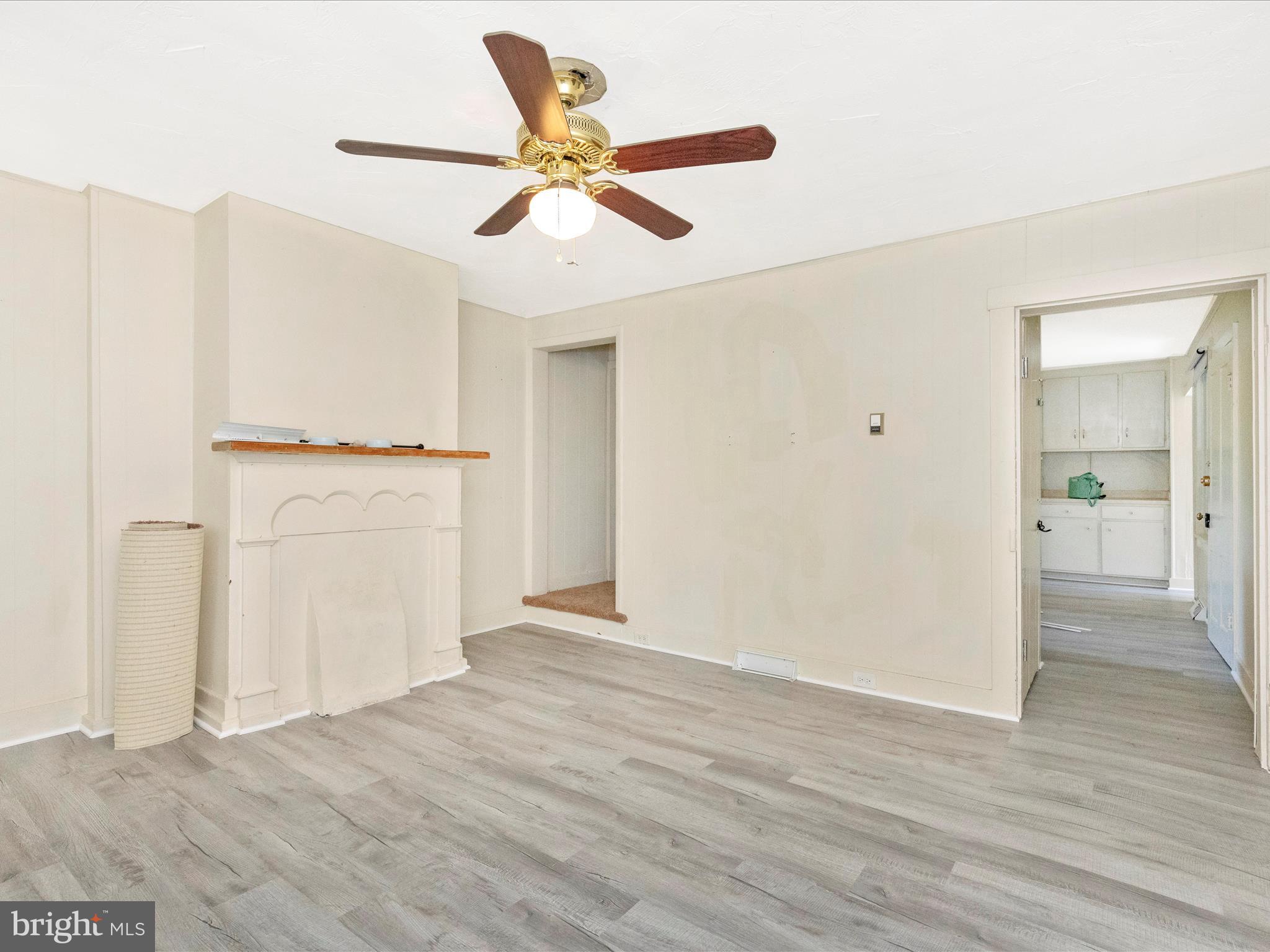 1404 Pleasant Valley Road, Unit 2 Westminster, MD 21158 - Photo 16 of 43 a view of a livingroom with wooden floor and a ceiling fan