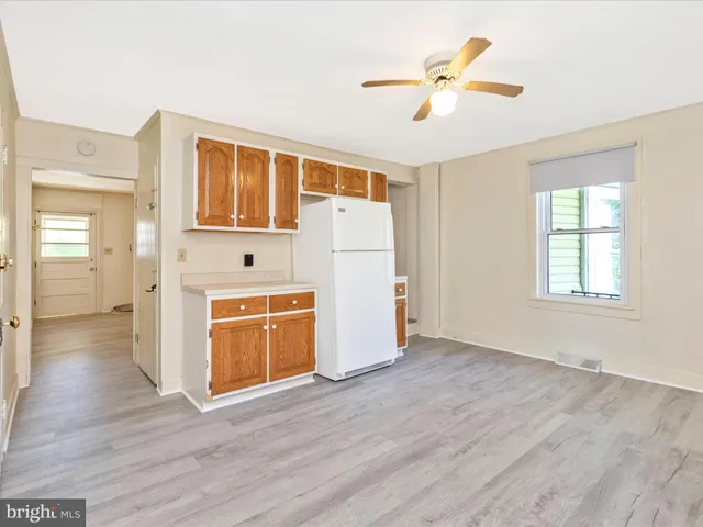 a view of kitchen with wooden floor electronic appliances and window