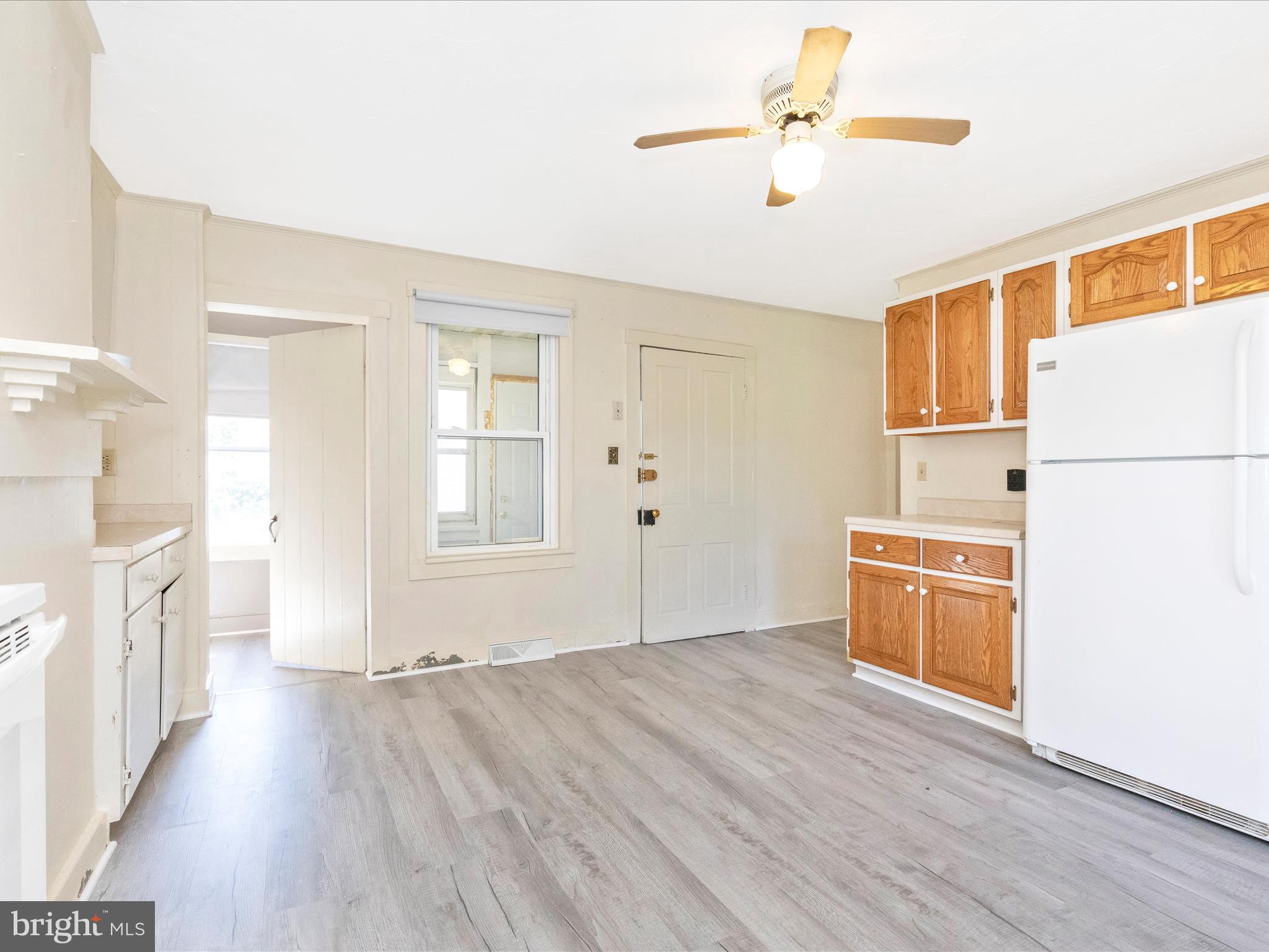 1404 Pleasant Valley Road, Unit 2 Westminster, MD 21158 - Photo 21 of 43 a view of a kitchen with a stove a refrigerator a ceiling fan and wooden floor