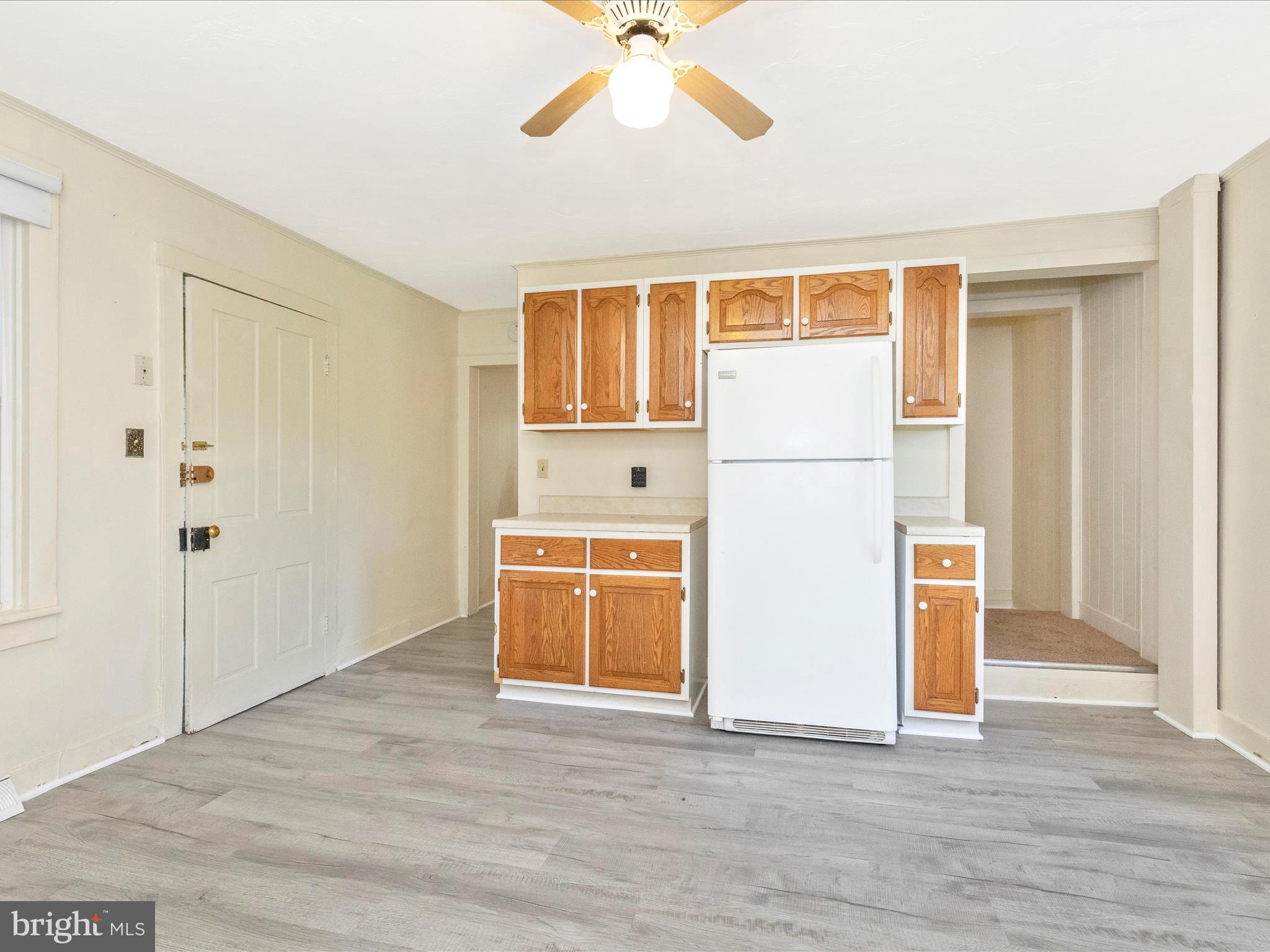 1404 Pleasant Valley Road, Unit 2 Westminster, MD 21158 - Photo 26 of 43 a view of a kitchen with wooden floor and a ceiling fan