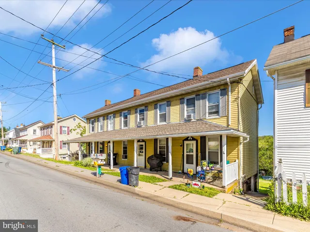 a front view of a house with a parking area