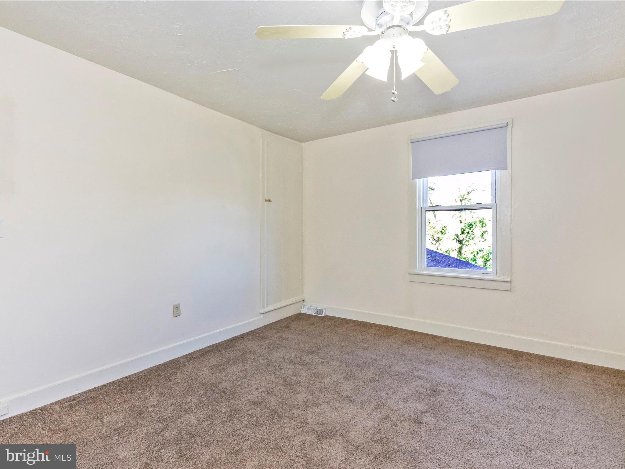 1404 Pleasant Valley Road, Unit 2 Westminster, MD 21158 - Photo 34 of 43 an empty room with a chandelier fan and windows