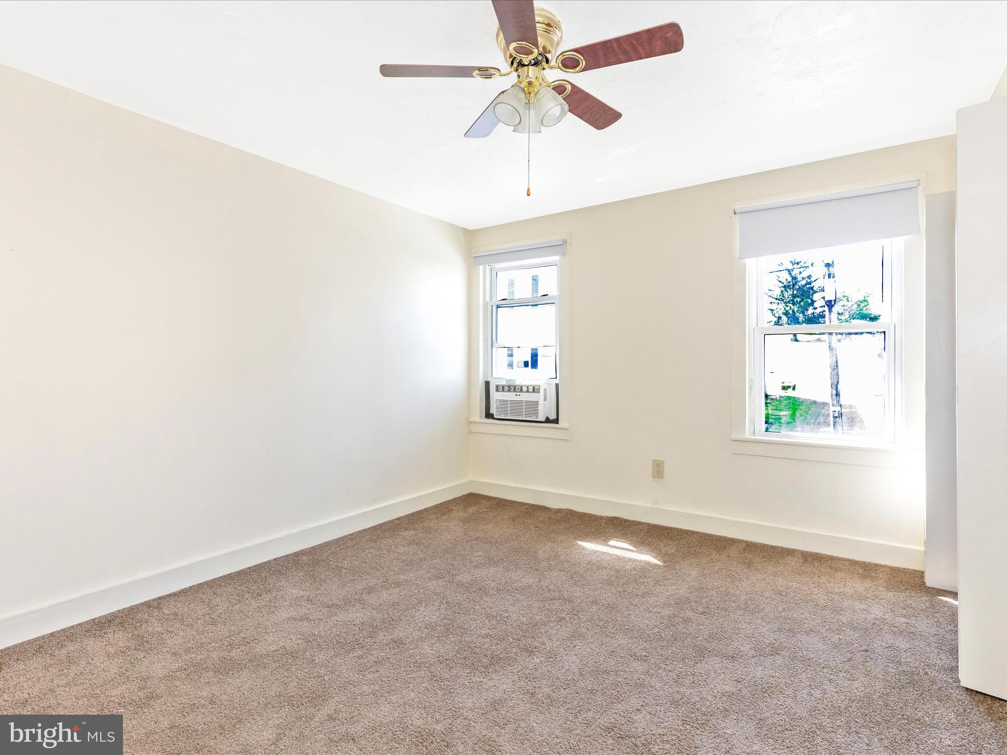 1404 Pleasant Valley Road, Unit 2 Westminster, MD 21158 - Photo 41 of 43 an empty room with windows and fan chandelier