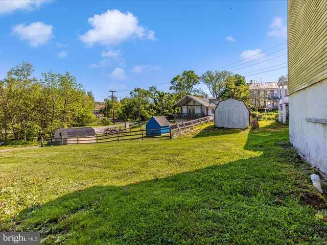 a view of a house with a yard and stairs