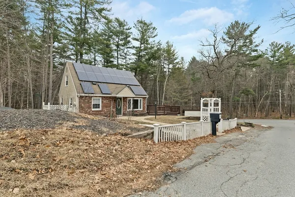 a view of a house with backyard and sitting area