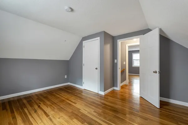 a view of a room with wooden floor