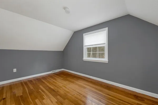 a view of a room with wooden floor and natural light
