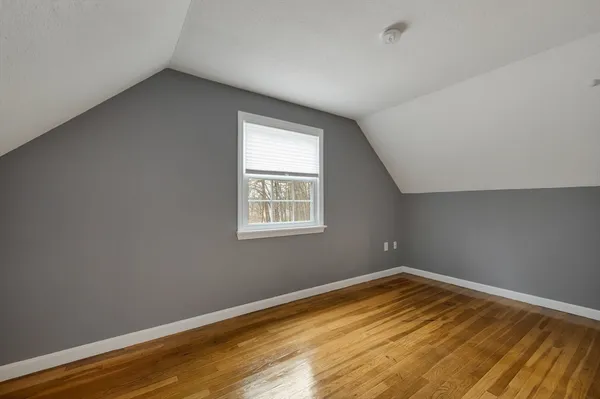 a view of a room with wooden floor and natural light