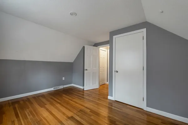 a view of room with wooden floor