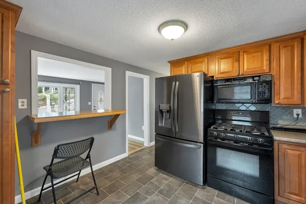 a kitchen with stainless steel appliances a refrigerator and a stove top oven