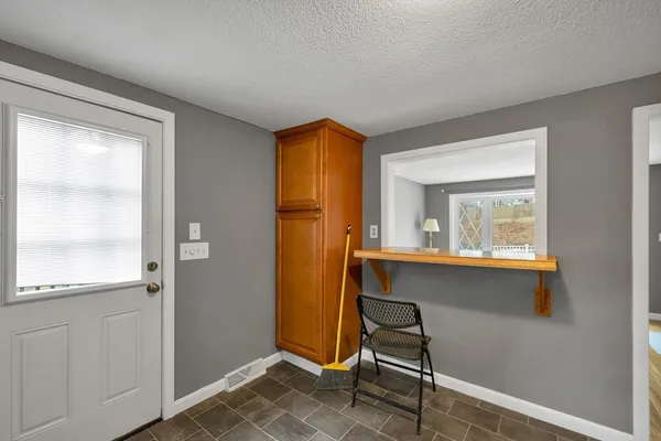 a bedroom with a window and wooden floor