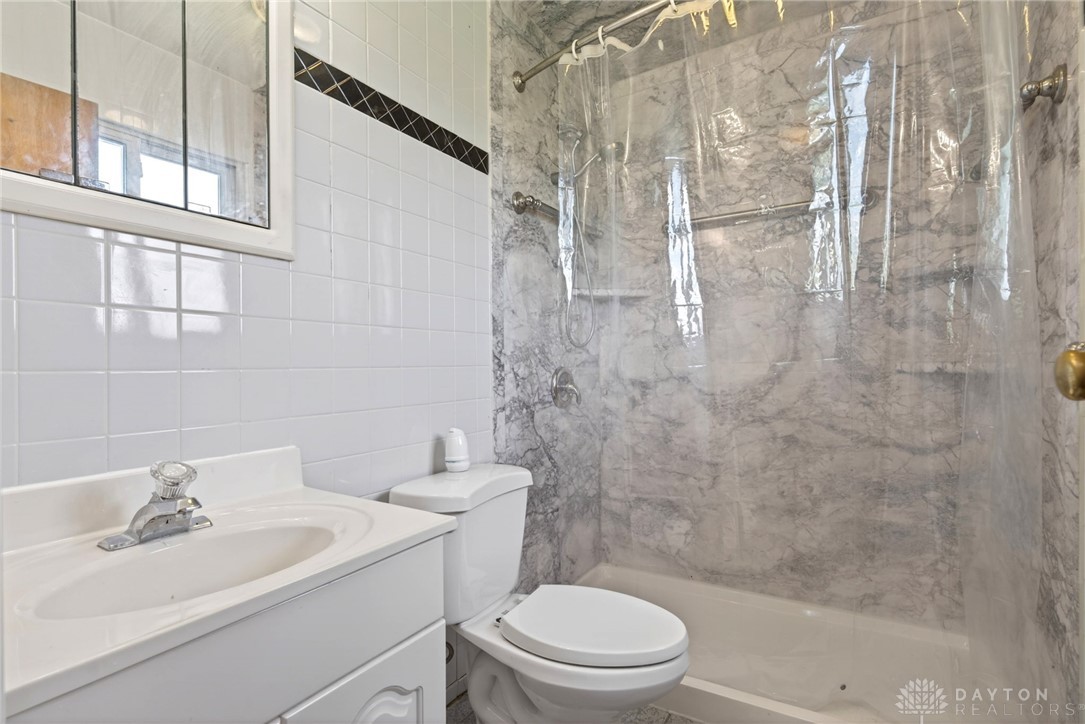 1005 Free Road New Carlisle, OH 45344 - Photo 21 of 43 This bright bathroom features a clean design with practical fixtures.