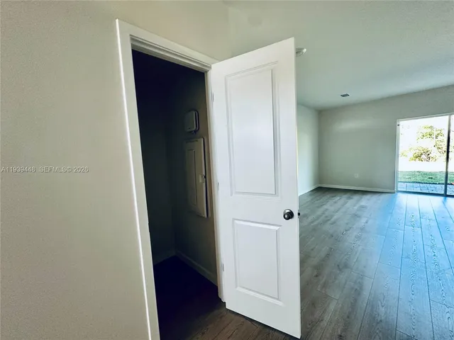 an empty room with wooden floor and closet