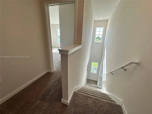a view of entryway and hall with wooden floor