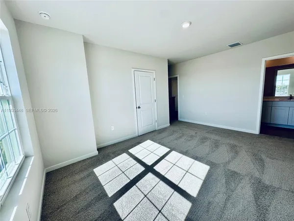 a view of an empty room and wooden floor