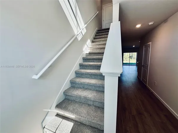 a view of entryway and hall with wooden floor