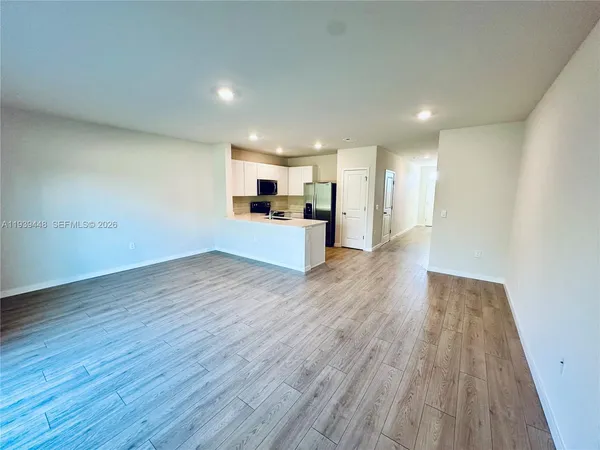 a view of a kitchen with wooden floor