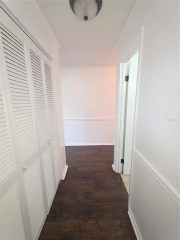 a view of a room with wooden floor and a sink