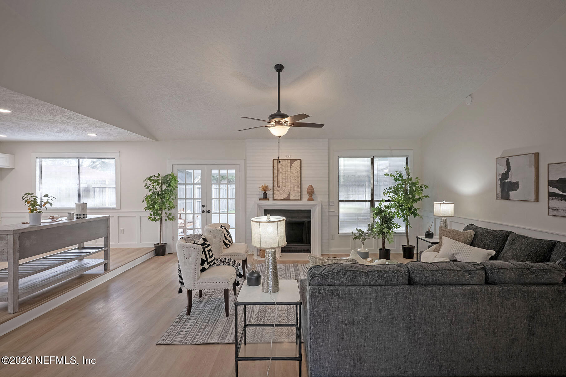 2451 Ridgecrest Avenue Orange Park, FL 32065 - Photo 16 of 57 a living room with furniture a chandelier and a dining table
