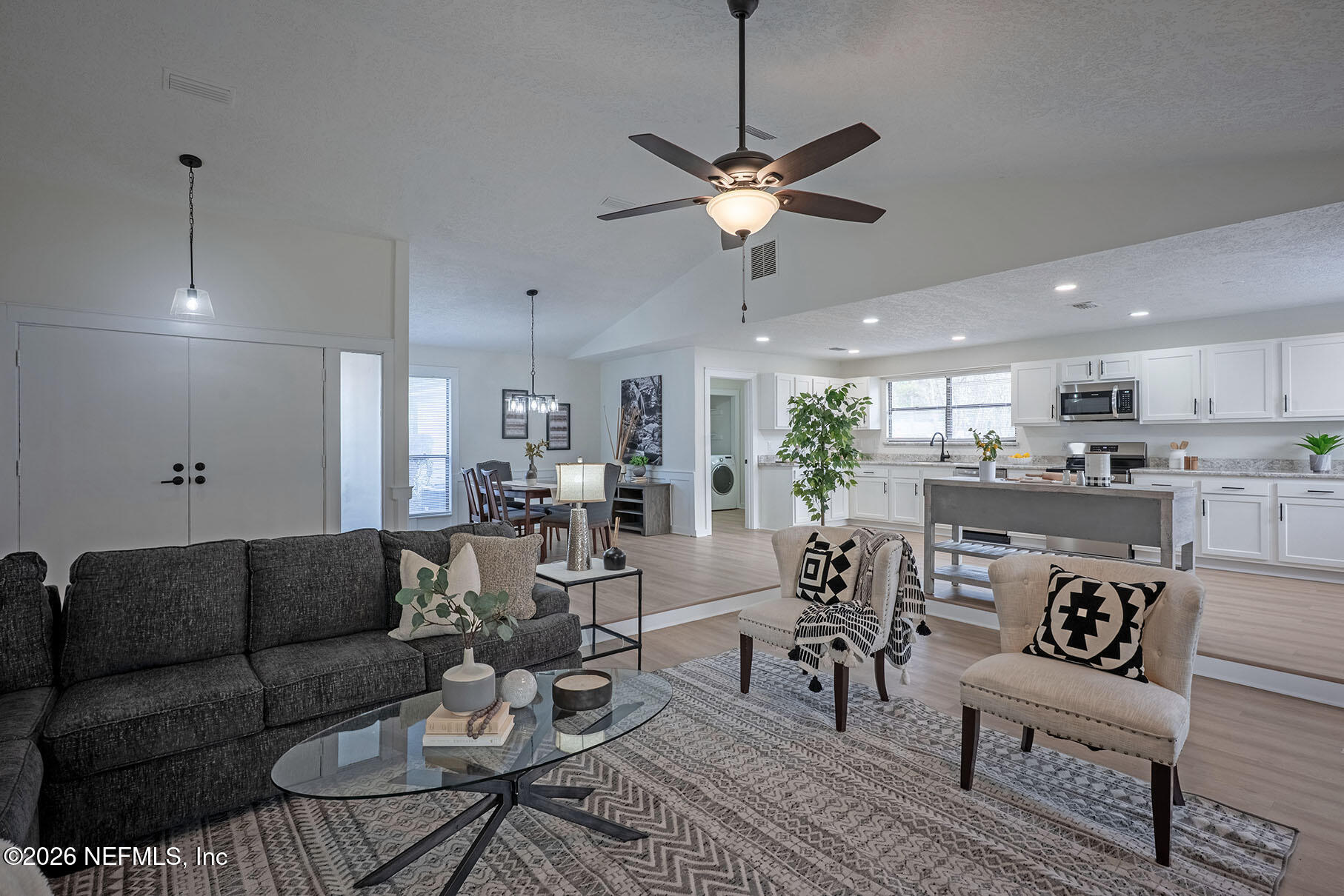 2451 Ridgecrest Avenue Orange Park, FL 32065 - Photo 20 of 57 a view of a dining room and livingroom with furniture wooden floor a chandelier