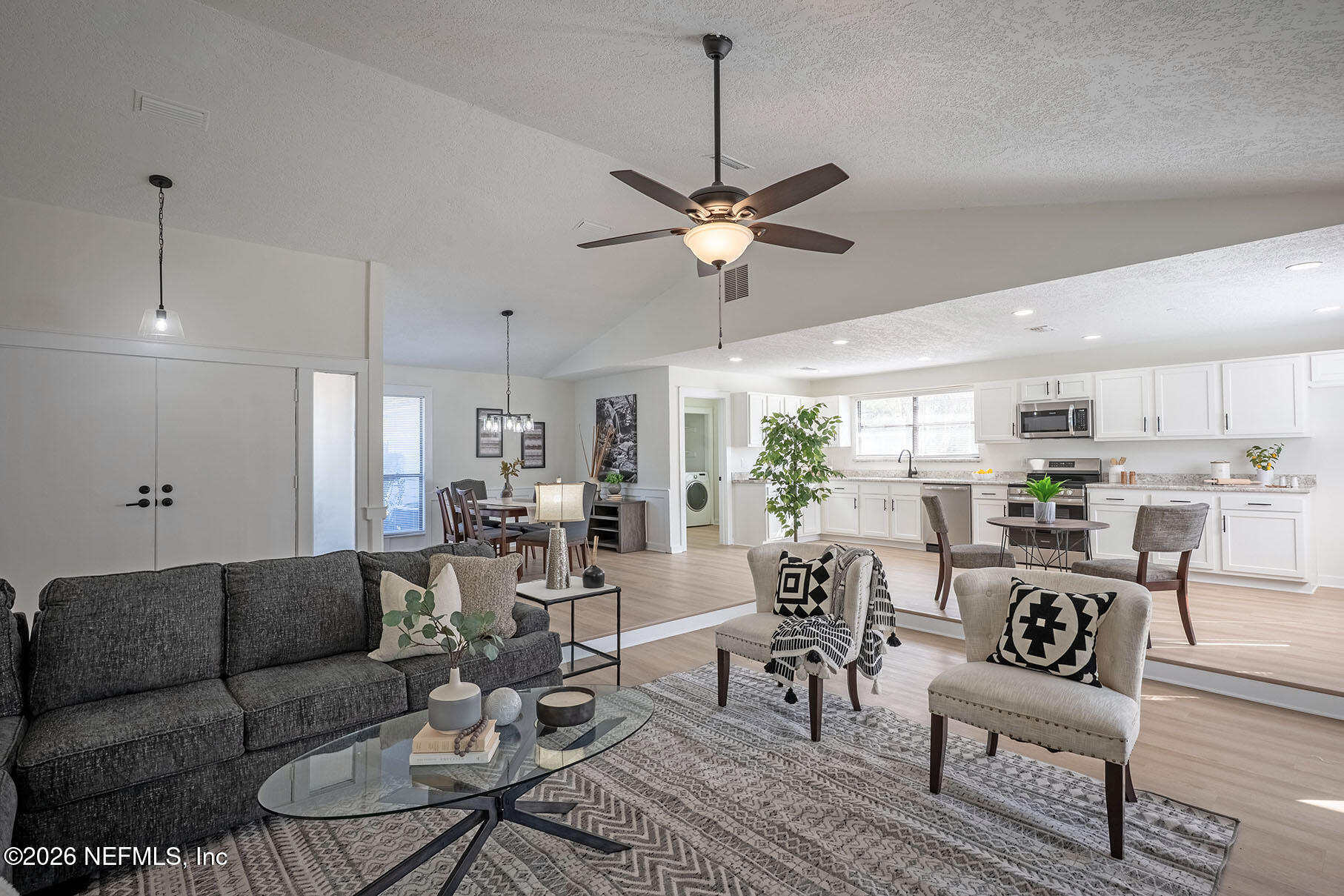 2451 Ridgecrest Avenue Orange Park, FL 32065 - Photo 25 of 57 a view of a dining room and livingroom with furniture wooden floor a chandelier