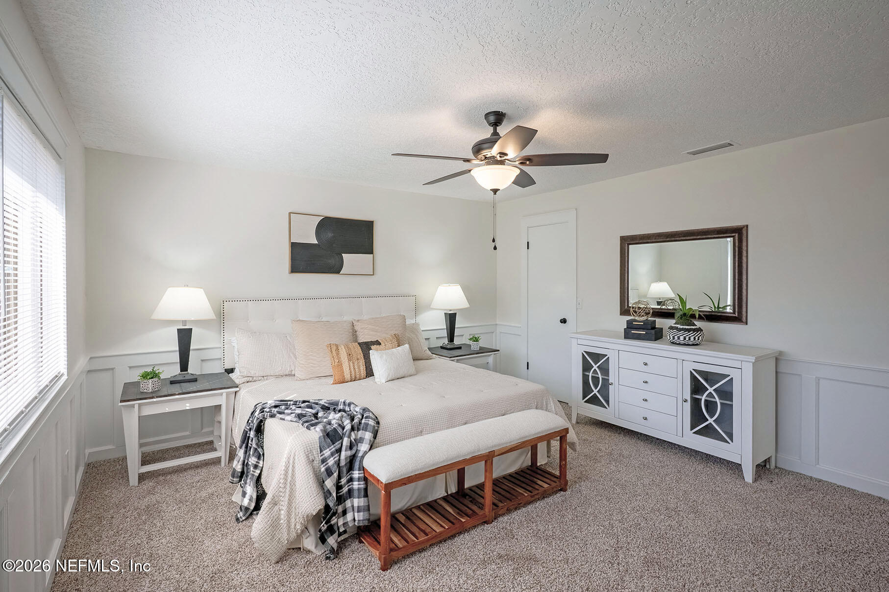 2451 Ridgecrest Avenue Orange Park, FL 32065 - Photo 29 of 57 a bedroom with a bed and a chandelier