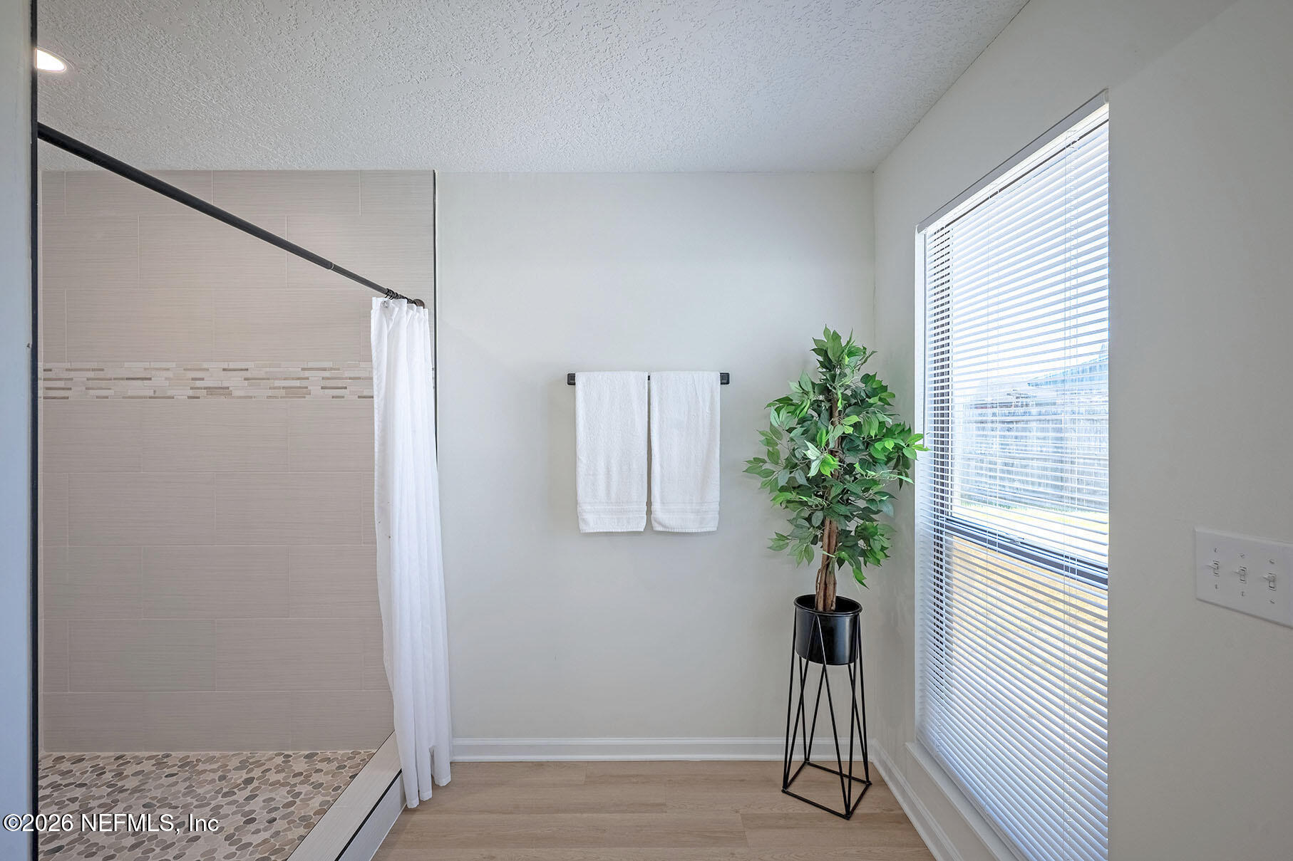 2451 Ridgecrest Avenue Orange Park, FL 32065 - Photo 32 of 57 a view of a hallway with wooden floor and a potted plant