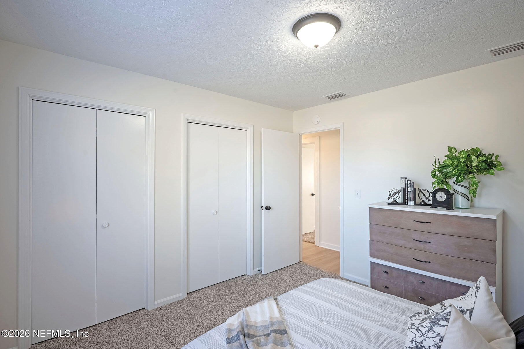 2451 Ridgecrest Avenue Orange Park, FL 32065 - Photo 36 of 57 a bedroom with a bed and a dresser