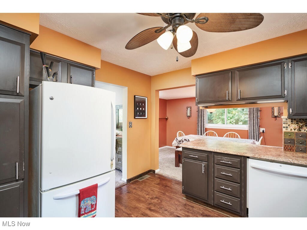 2643 Massillon Road Akron, OH 44312 - Photo 7 of 33 Kitchen with ceiling fan, dark carpet, decorative backsplash, and white appliances