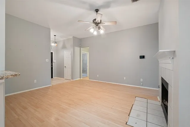 a view of an empty room with a ceiling fan and bathroom