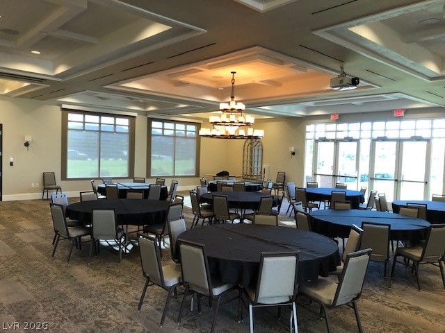 498 Pebble Run Avenue Henderson, NV 89011 - Photo 37 of 47 A well-appointed event space featuring multiple round tables and a projector for presentations.