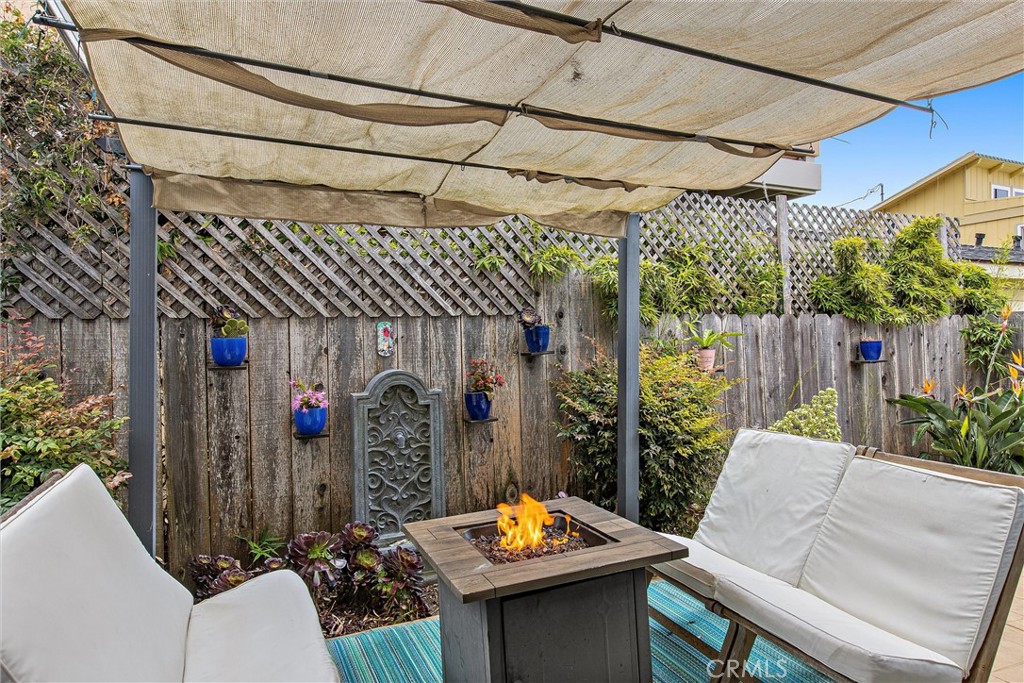 440 Java Street Morro Bay, CA 93442 - Photo 15 of 22 a outdoor living space with furniture and a black umbrella
