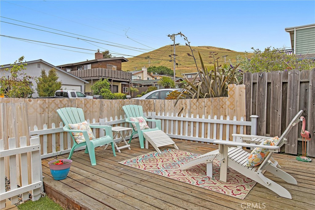 440 Java Street Morro Bay, CA 93442 - Photo 4 of 22 a view of a roof deck with table and chairs and wooden floor