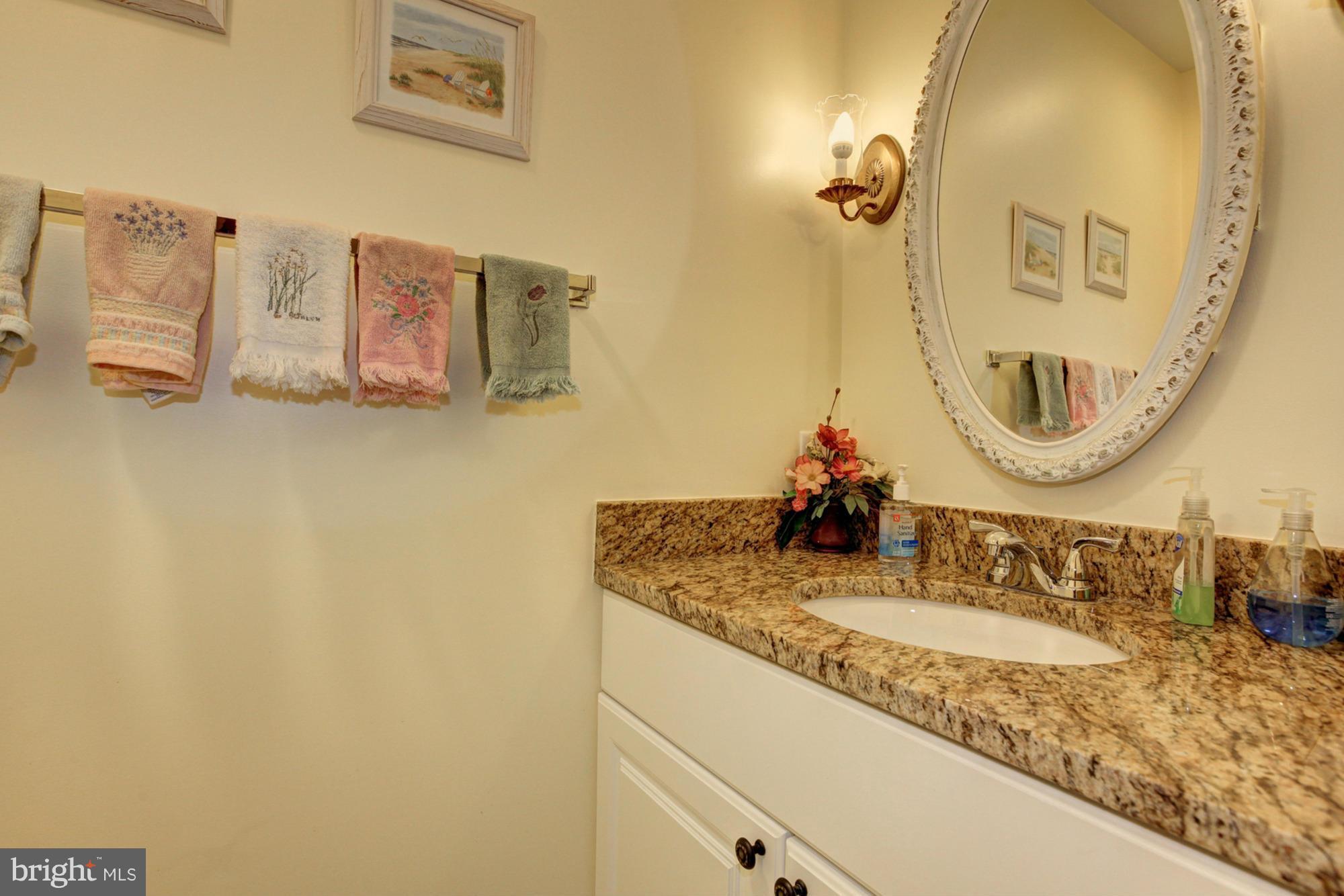4817 Sangamore Road, Unit 8 Bethesda, MD 20816 - Photo 14 of 28 a bathroom with a granite countertop sink and a mirror