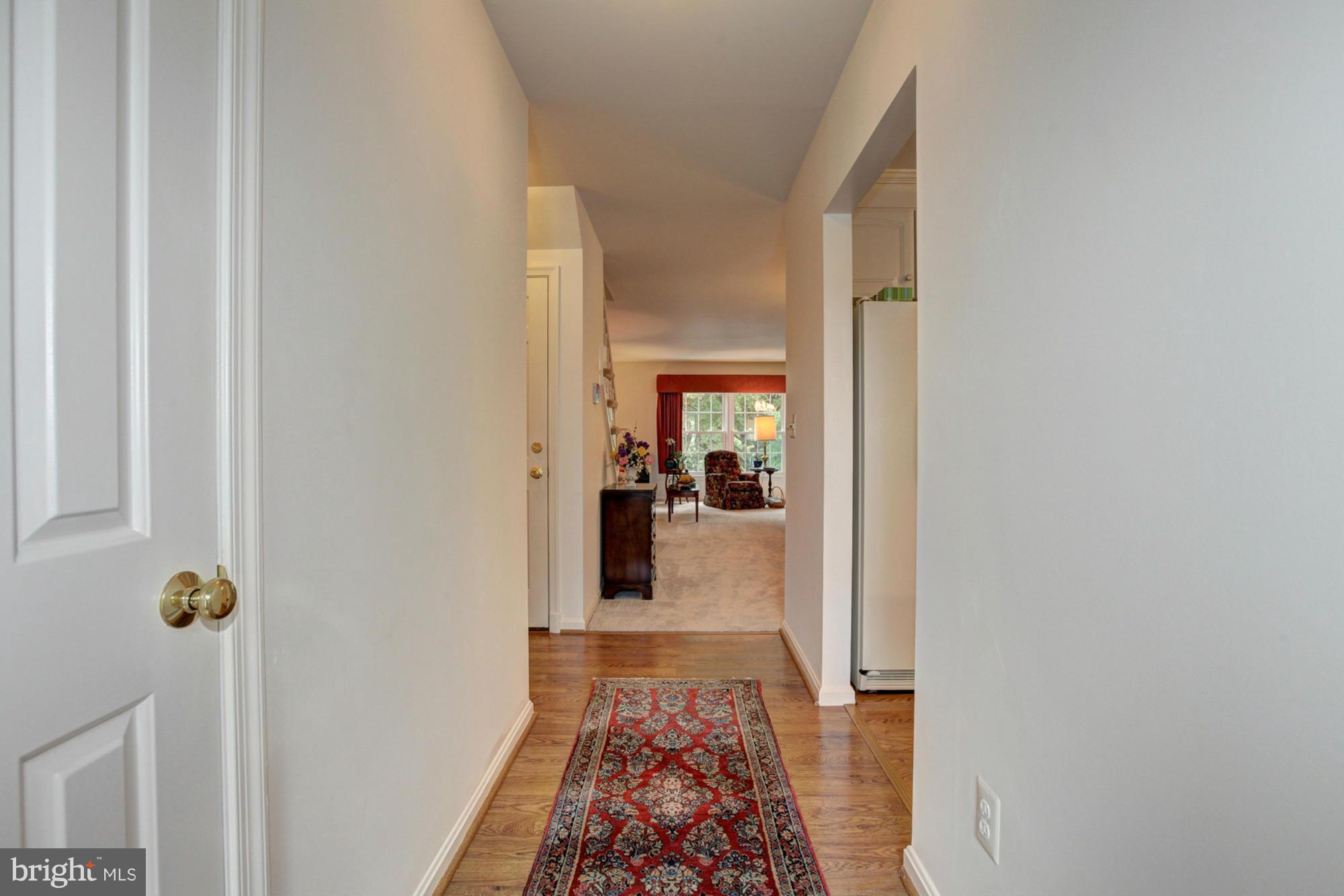 4817 Sangamore Road, Unit 8 Bethesda, MD 20816 - Photo 3 of 28 a hallway with a view of bedroom with wooden floor