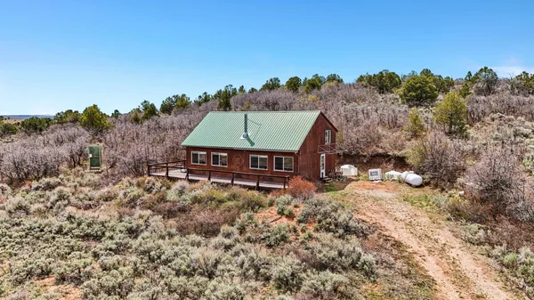 an aerial view of a house with a yard