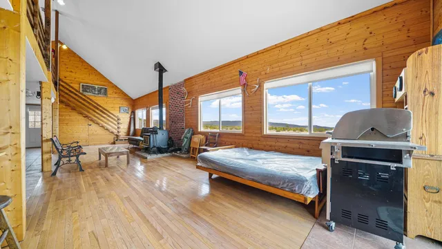 a bedroom with furniture and a large window