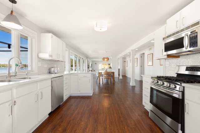 35013 North James Ingleside, IL 60041 - Photo 16 of 46 a kitchen with stainless steel appliances a white stove top oven a sink dishwasher and a refrigerator with wooden floor