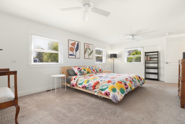 35013 North James Ingleside, IL 60041 - Photo 19 of 46 a bedroom with a bed and a chandelier