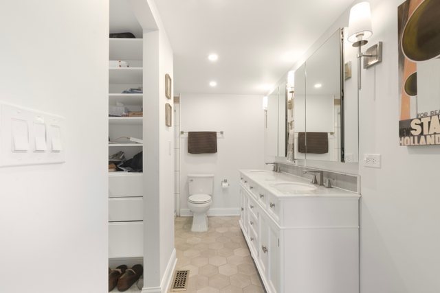 35013 North James Ingleside, IL 60041 - Photo 21 of 46 a spacious bathroom with a toilet a sink and mirror