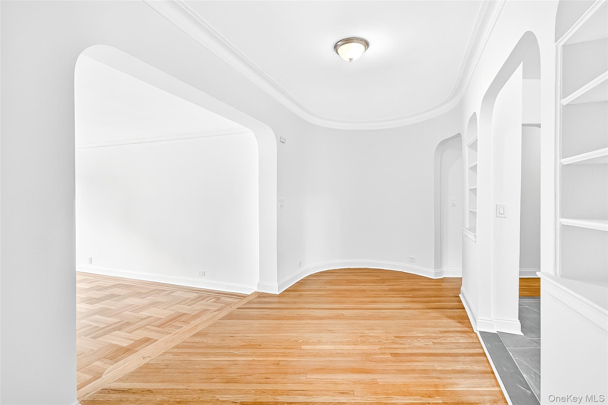190 East Mosholu Parkway South, Unit 3C Bronx, NY 10458 - Photo 20 of 50 Corridor featuring ornamental molding, arched walkways, and parquet flooring