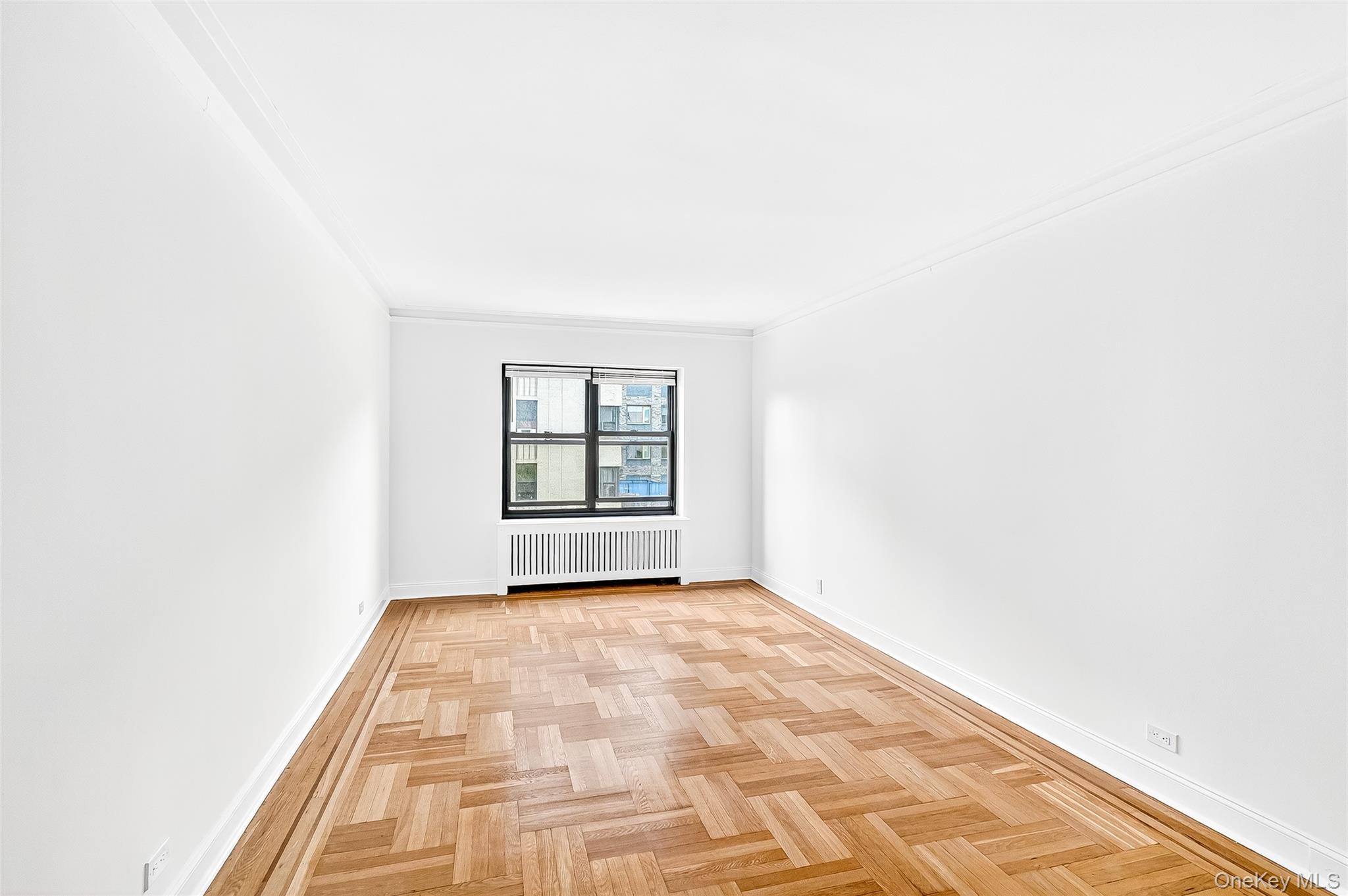 190 East Mosholu Parkway South, Unit 3C Bronx, NY 10458 - Photo 21 of 50 Spare room featuring radiator and ornamental molding