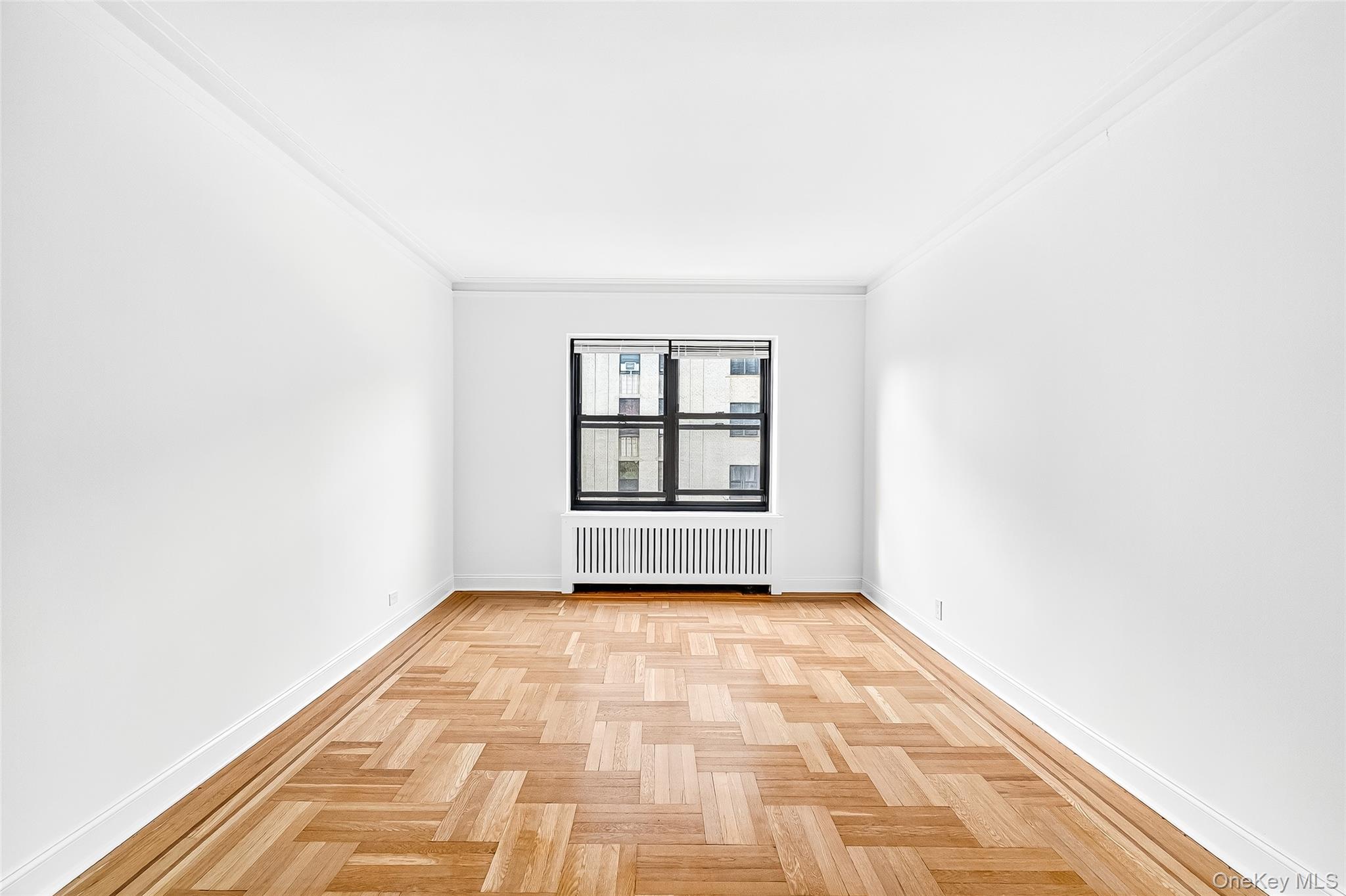 190 East Mosholu Parkway South, Unit 3C Bronx, NY 10458 - Photo 22 of 50 Unfurnished room with radiator heating unit and crown molding