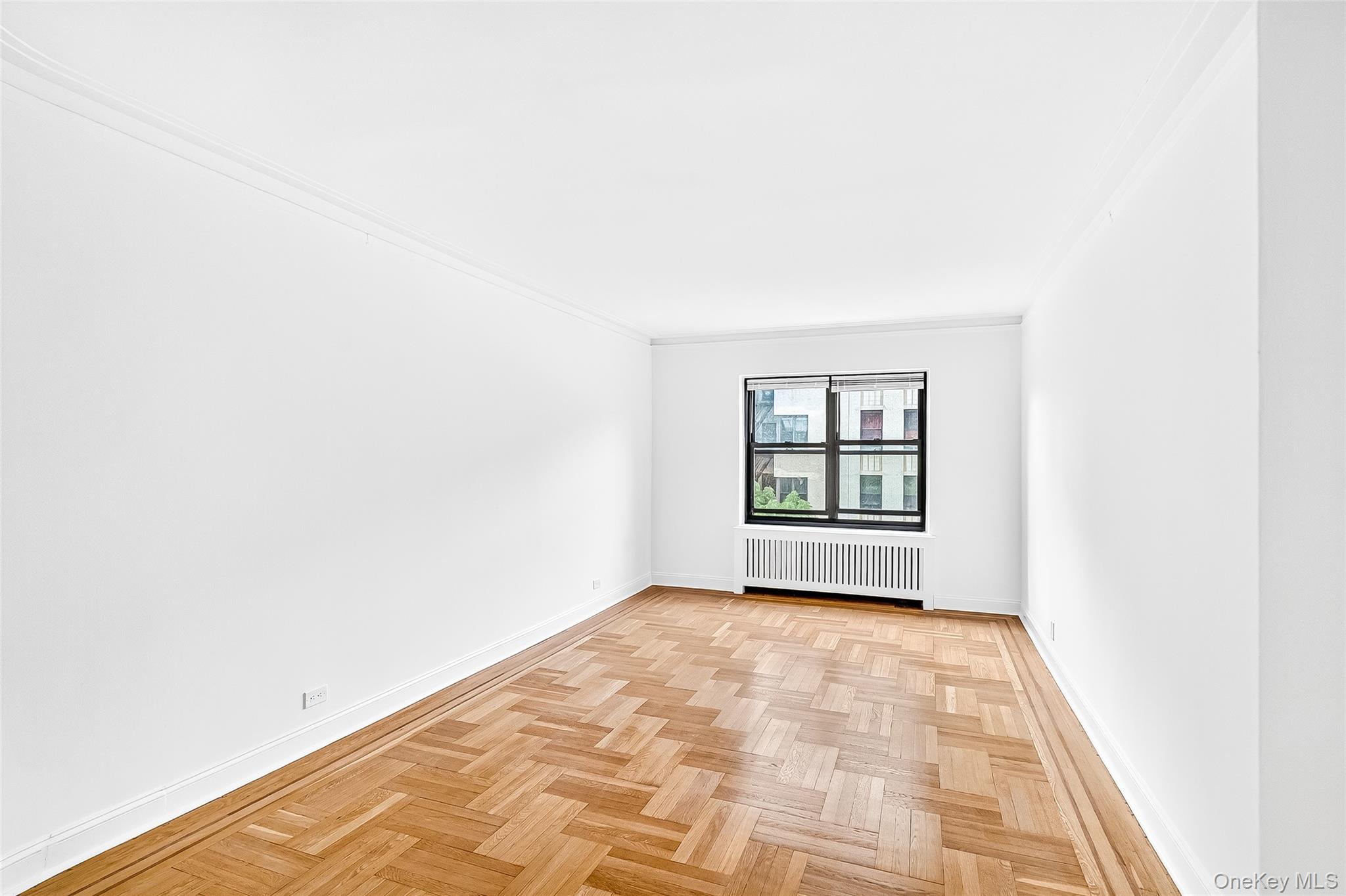 190 East Mosholu Parkway South, Unit 3C Bronx, NY 10458 - Photo 23 of 50 Unfurnished room with radiator heating unit and ornamental molding